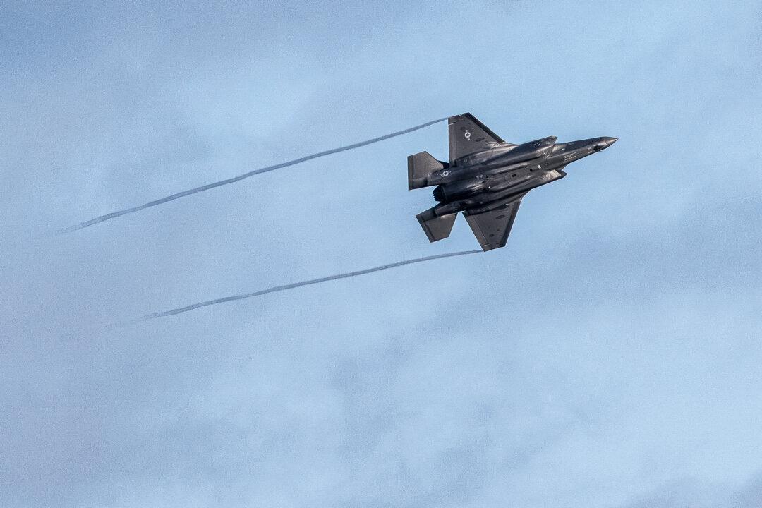 (Top Left) A U.S. F-15 fighter plane prepares for landing in Mildenhall, England, on Jan. 7, 2026. (Top Right) B-2 Spirit Bombers fly over the White House on July 4, 2025. (Bottom Left) A U.S. F-35 fighter plane takes off in Mildenhall, England, on Jan. 7, 2026. (Bottom Right) A U.S. Air Force F22-Raptor takes off in Ceiba, Puerto Rico, on Jan. 4, 2026. (Dan Kitwood/Getty Images, Eric Lee/Getty Images, Miguel J. Rodriguez Carrillo / AFP via Getty Images)