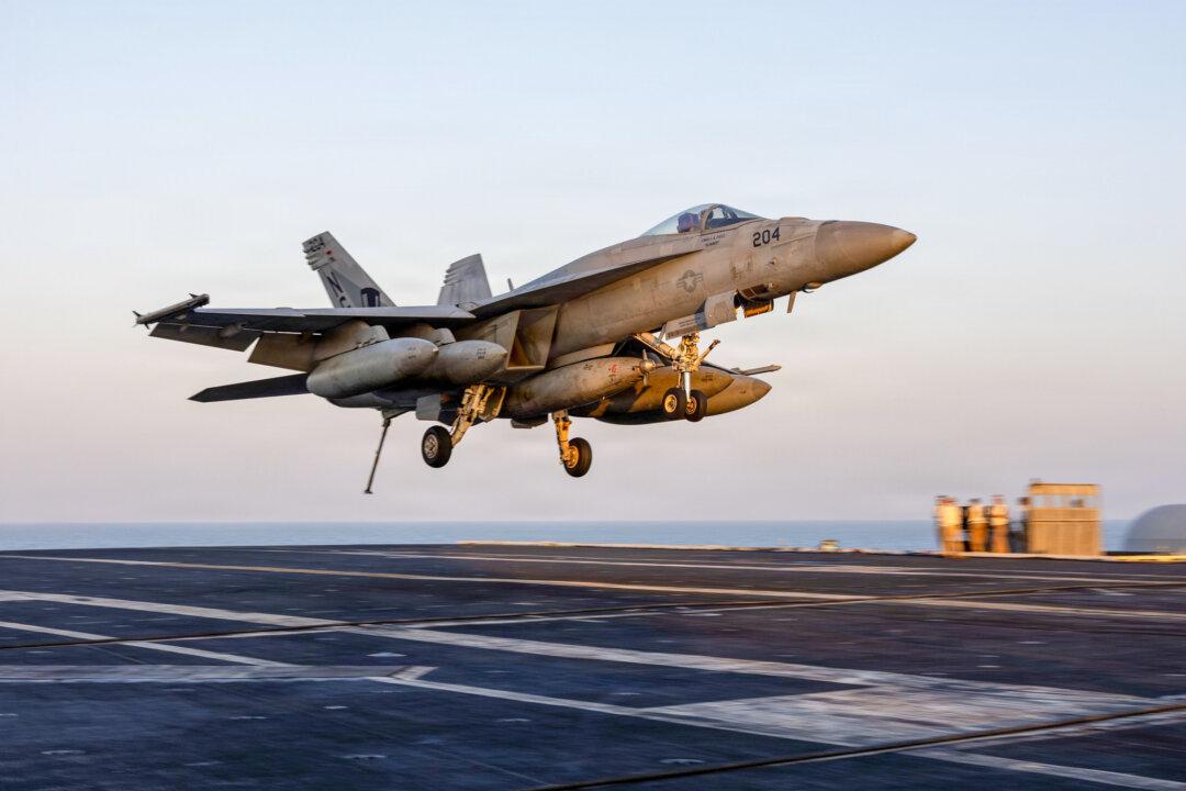 (Top) Nimitz-class aircraft carrier USS Abraham Lincoln (CVN 72), Arleigh Burke-class guided-missile destroyers USS Michael Murphy (DDG 112), USS Frank E. Petersen Jr. (DDG 121), Henry J. Kaiser-class fleet replenishment oiler USNS Henry J. Kaiser (T-AO-187), Lewis and Clark-class dry cargo ship USNS Carl Brashear (T-AKE 7), and U.S. Coast Guard Sentinel-class fast-response cutters USCG Robert Goldman (WPC-1142) and USCGC Clarence Sutphin. Jr. (WPC-1147) sail in formation in the Arabian Sea, on Feb. 6, 2026. (Bottom Left) An F/A-18E Super Hornet, attached to Strike Fighter Squadron (VFA) 14, prepares to land on the flight deck of aircraft carrier USS Abraham Lincoln (CVN 72) during Operation Epic Fury at Sea on March 1, 2026. (Bottom Right) U.S. sailors prepare to stage ordnance on the flight deck of the USS Abraham Lincoln on Feb. 28, 2026. (Mass Communication Specialist 1st Class Jesse Monford/U.S. Navy via Getty Images, U.S. Navy via Getty Images)
