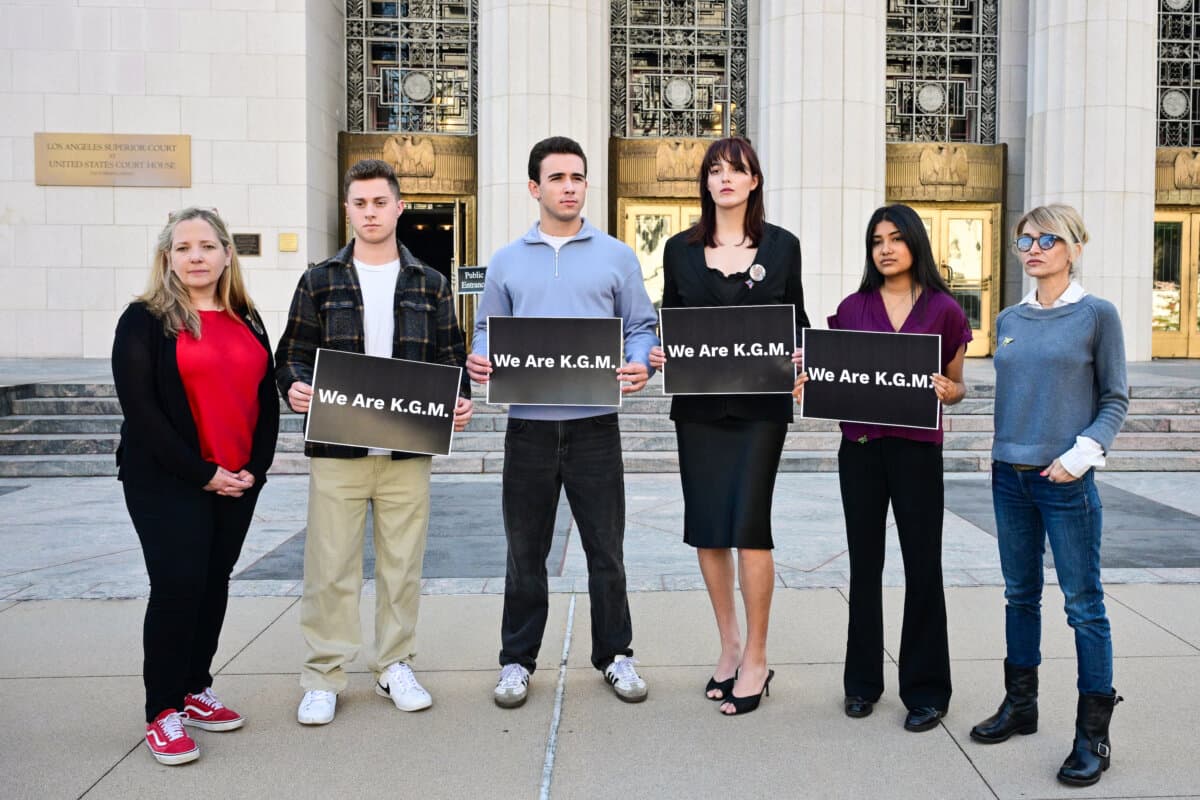 Supporters of "K.G.M." pose with signs outside the Los Angeles Superior Court on Feb. 25, 2026, during the social media trial over whether platforms were deliberately designed to be addictive to children. (Frederic J. Brown/AFP via Getty Images)