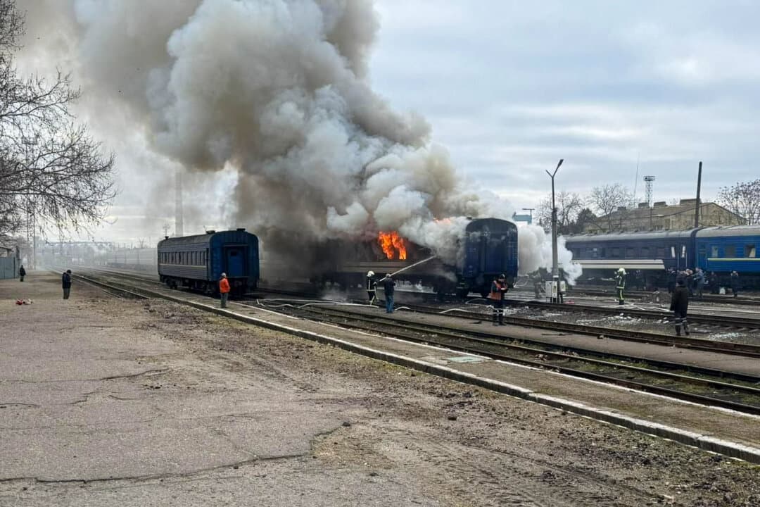 Firefighters douse a passenger train after it was hit by a Russian drone strike at a railway station in Mykolaiv region, Ukraine, on March 4, 2026. (Oleksii Kuleba via Facebook/Handout via Reuters)
