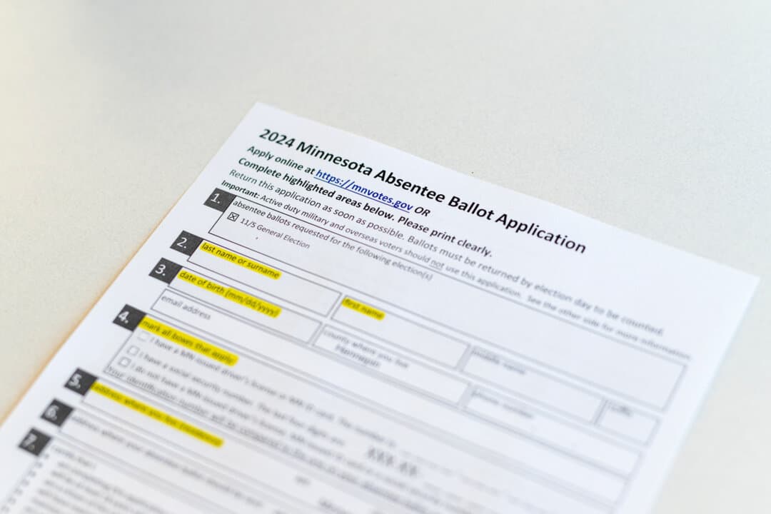 An absentee ballot request form is displayed at the Minneapolis Elections & Voter Services building in Minneapolis on Sept. 20, 2024. A new Minnesota law moves the in-person mail ballot deadline to 5 p.m. on Election Day and requires an ID number and the last four digits of a Social Security number to request a ballot. (Stephen Maturen/Getty Images)