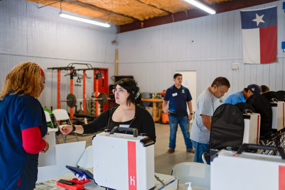 An election clerk hands a voter a ballot at Westfield Road Volunteer Fire Department Station 2 in the East Aldine Community of Houston on Nov. 5, 2024. (Danielle Villasana/Getty Images)