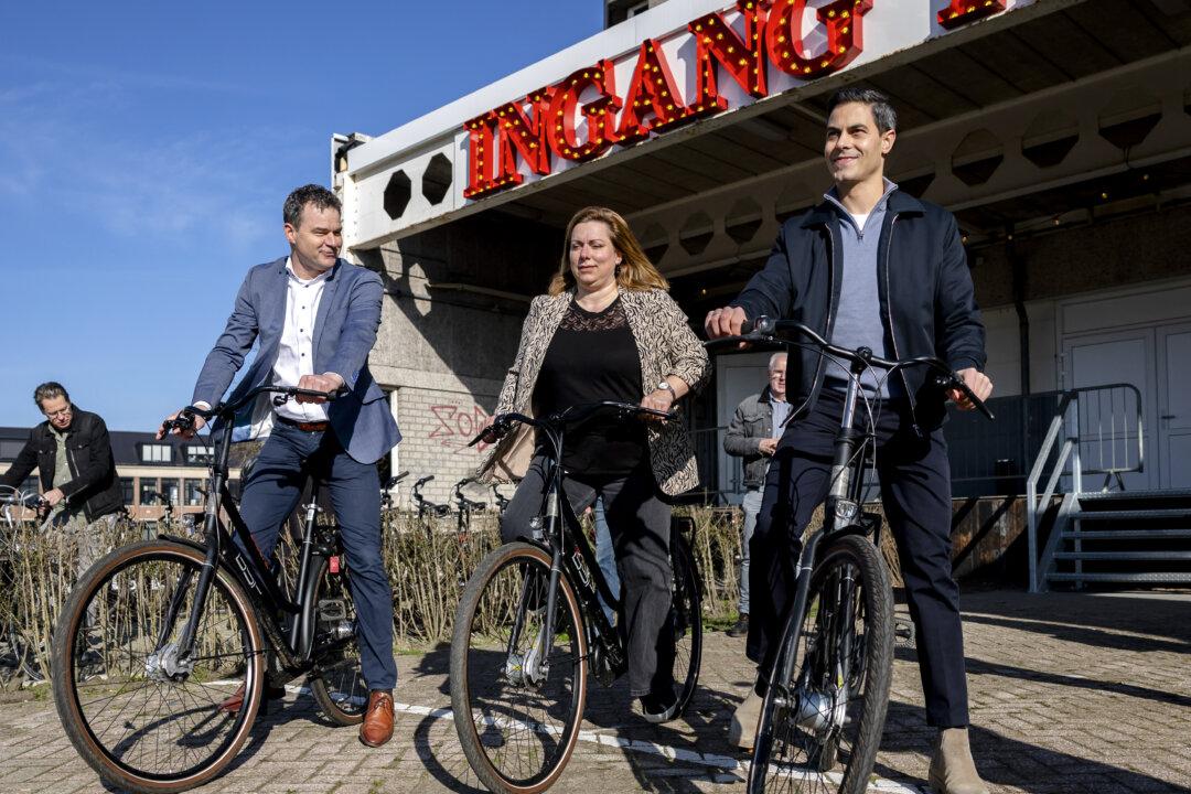 Dutch Prime Minister Rob Jetten gets on his bike during a visit to projects that are part of the National Program for Livability and Safety in Roosendaal, Netherlands, on March 5, 2026. Within this program, schools and businesses collaborate to improve the quality of life and safety in neighborhoods. (Remko De Waal/Anp/AFP via Getty Images)