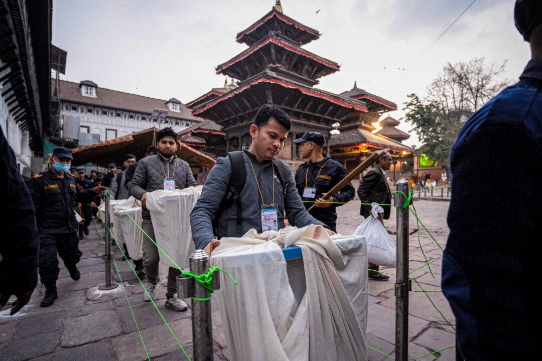 Security personnel escort electoral officials carrying ballot boxes to the counting center after voting ends at a polling station during Nepal's general election in Kathmandu, on March 5, 2026. Nepal voted for a new parliament. (Prabin Ranabhat/AFP via Getty Images)