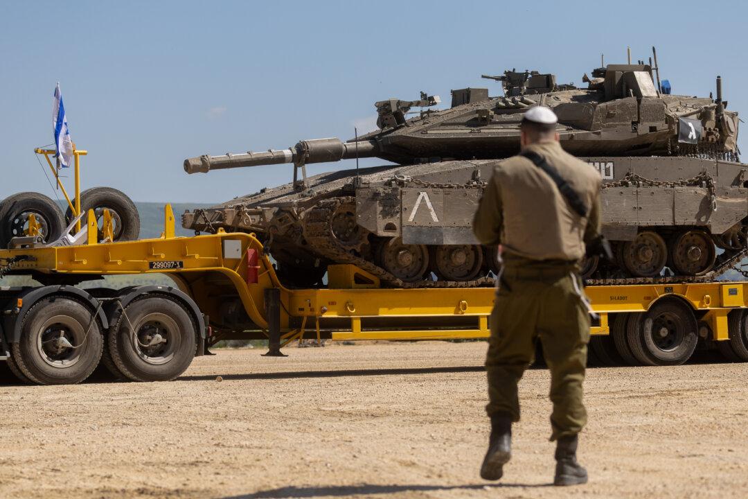 An Israeli soldier stands near a truck carrying an Israeli tank near the border with Lebanon in northern Israel, on March 5, 2026. Hezbollah launched missiles at Israel in what it said was retaliation for the joint U.S.-Israeli war on Iran. (Amir Levy/Getty Images)