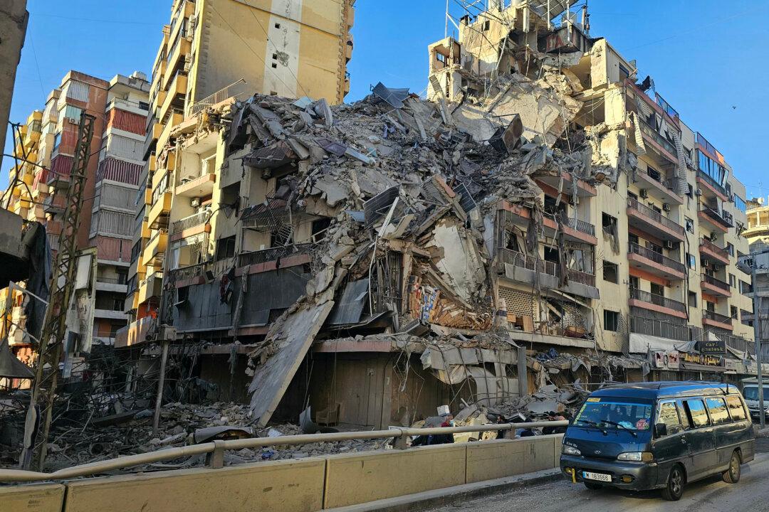 A van drives past a destroyed building following airstrikes in Beirut's southern suburbs of Ghobeiry neighborhood, Lebanon, on March 5, 2026. Israel said it carried out strikes on Beirut targeting Iran-backed militant group Hezbollah on March 5, while Lebanese state media reported an Israeli drone strike killed a Hamas official. (AFP via Getty Images)