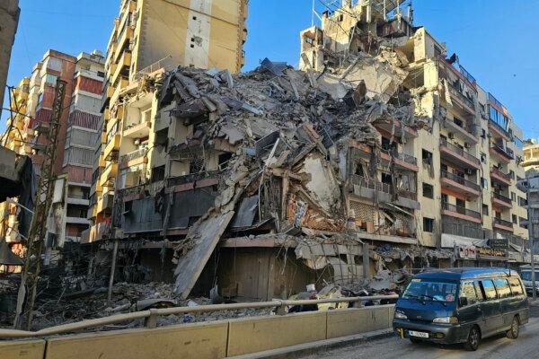 A van drives past a destroyed building following airstrikes in Beirut's southern suburbs of Ghobeiry neighborhood, Lebanon, on March 5, 2026. (AFP via Getty Images)