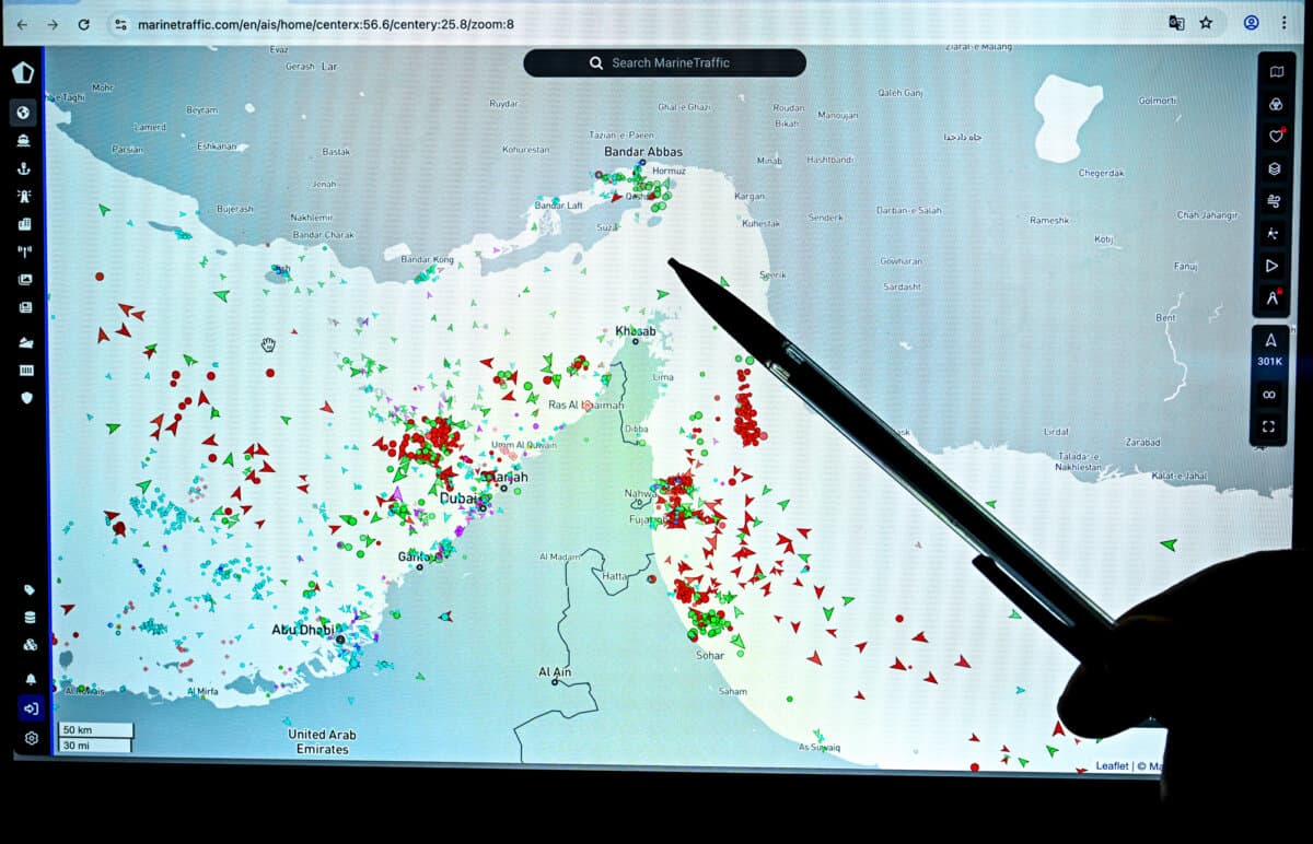 A person points at a page on the MarineTraffic website that shows commercial maritime traffic on the edge of the Strait of Hormuz near the Iranian coast amid the ongoing war in the Middle East, in Paris on March 4, 2026. (Julien De Rosa/AFP via Getty Images)