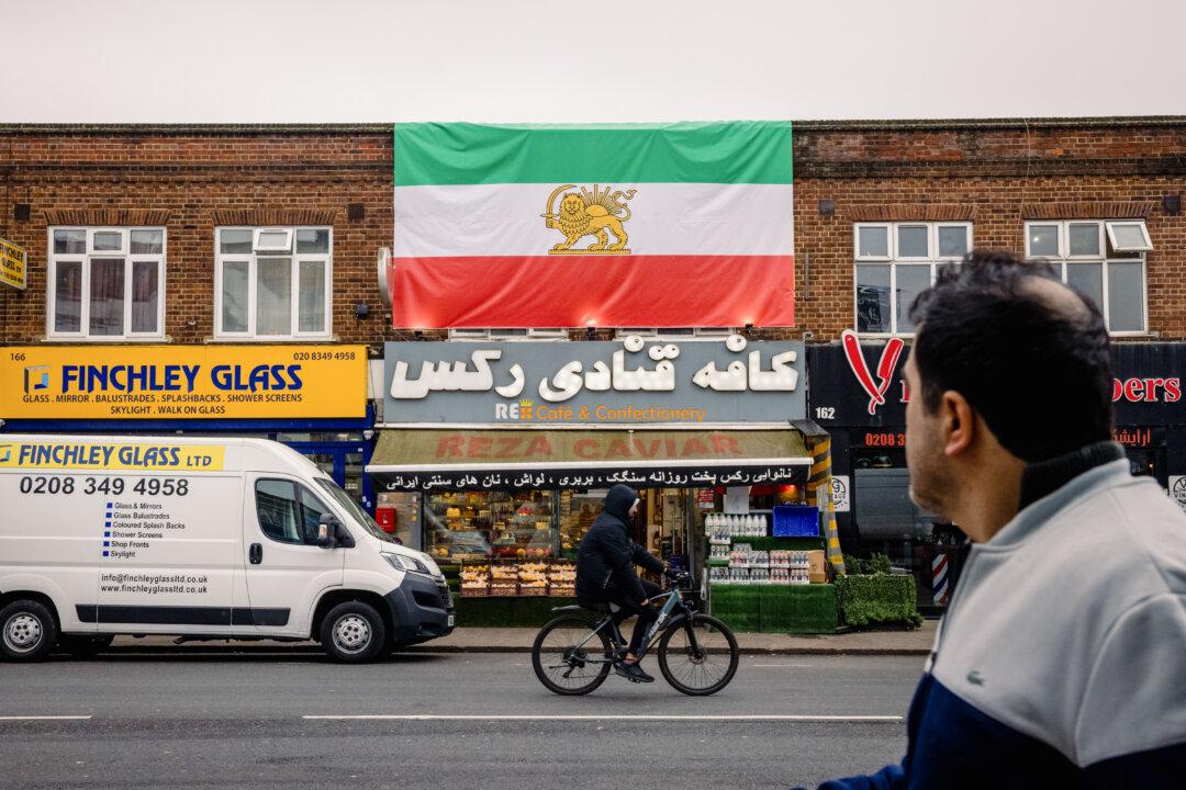 A pre-Iranian Revolution Lion and Sun national flag hangs from the roof of an Iranian patisserie in London on March 6, 2026. (Jack Taylor/Getty Images)