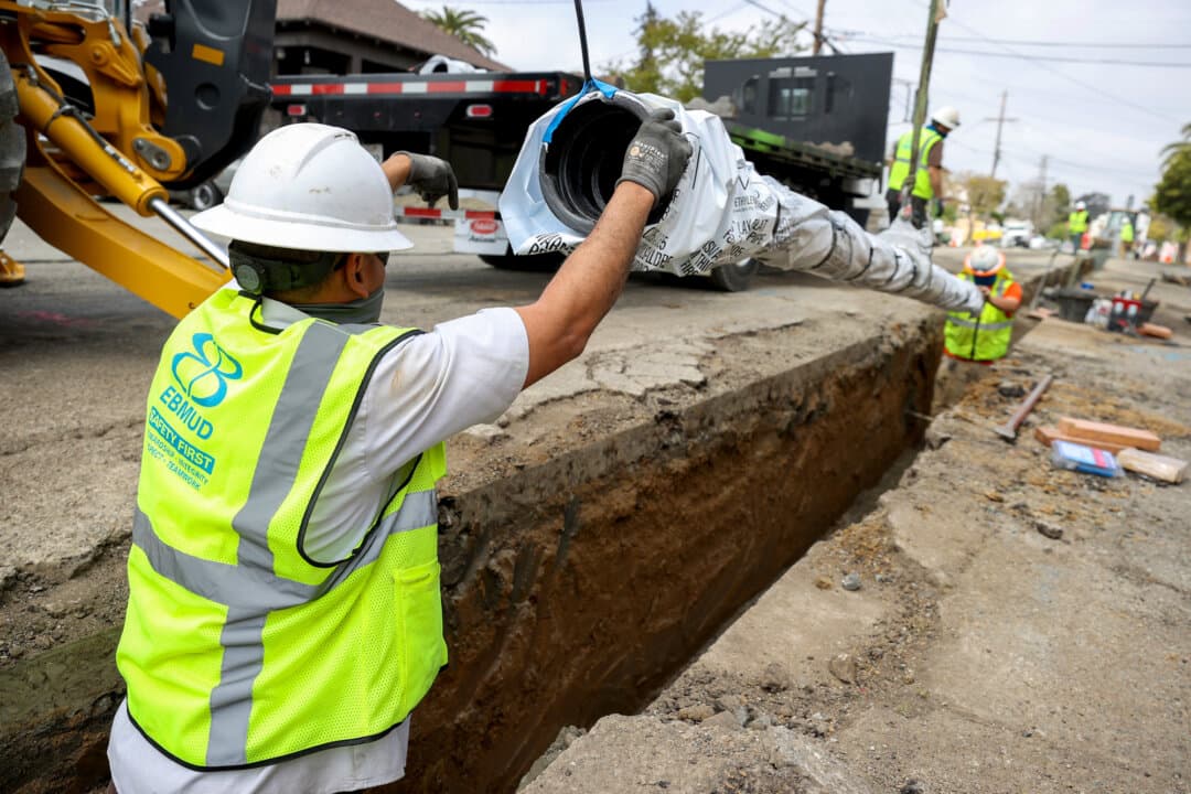 Workers with the East Bay Municipal Utility District install a new water pipe in Oakland, Calif., on April 22, 2021. The Environmental Protection Agency issued a final rule in 2024 requiring water systems nationwide to identify and replace lead pipes within 10 years. (Justin Sullivan/Getty Images)