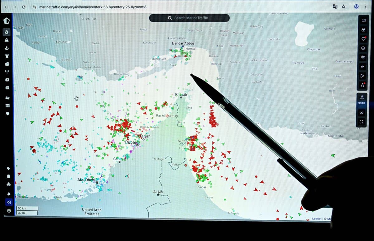 A person points at a page on the Marinetraffic website that shows commercial boats traffic on the edge of the Strait of Hormuz near the Iranian coast, in Paris on March 4, 2026. (Julien de Rosa / AFP via Getty Images)