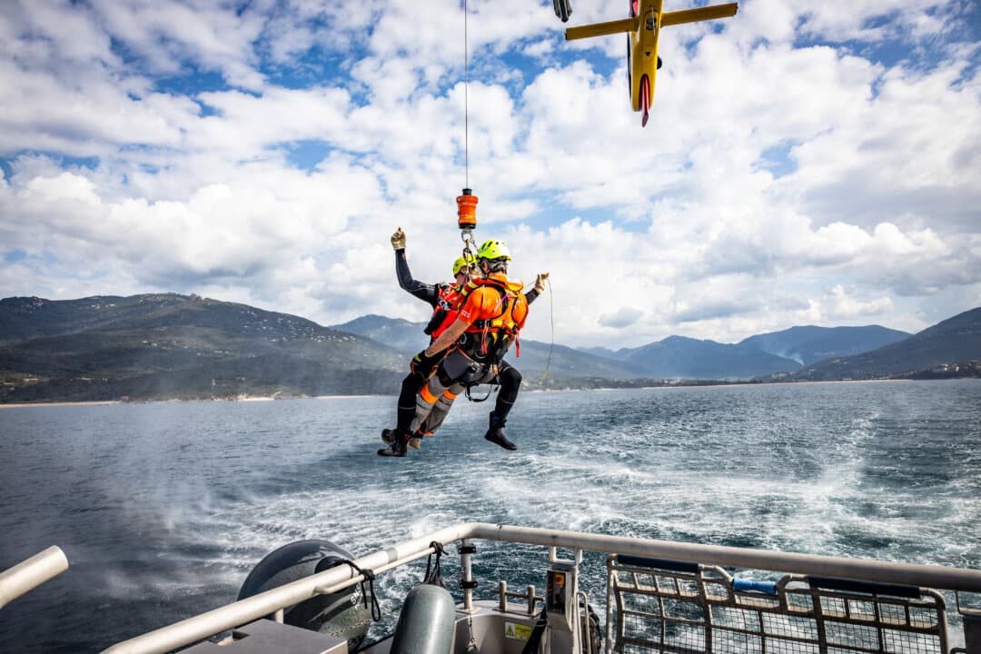 A rescuer is hoisted by a helicopter of the French Civil Protection during a joint rescue training exercise with the SNSM off the coast of Propriano, Corsica, France, on March 12, 2026. (Grichka Beysson-Leandri/Hans Lucas/AFP via Getty Images)