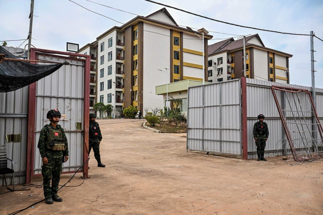 Royal Thai Army soldiers stand outside an abandoned scam centre in O'Smach town on the Thai-Cambodian border on March 12, 2026, during a press trip organized by Thailand's Ministry of Foreign Affairs and the Royal Thai Army. (Lillian Suwanrumpha/AFP via Getty Images)