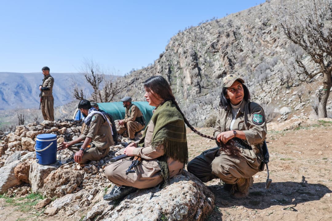 Members of Komala of the Toilers of Kurdistan, a Kurdish Iranian dissident group, are braiding their hair at their military bases hidden among the mountains in Khalifa, Iraq, on March 12, 2026. While all eyes are on the continuing U.S. and Israeli strikes against Iran, another potential battlefront is brewing on the border with Iraq; Kurdish militia fighters are preparing for war with the hope of liberating their fellow Kurds in western Iran. (Sedat Suna/Getty Images)