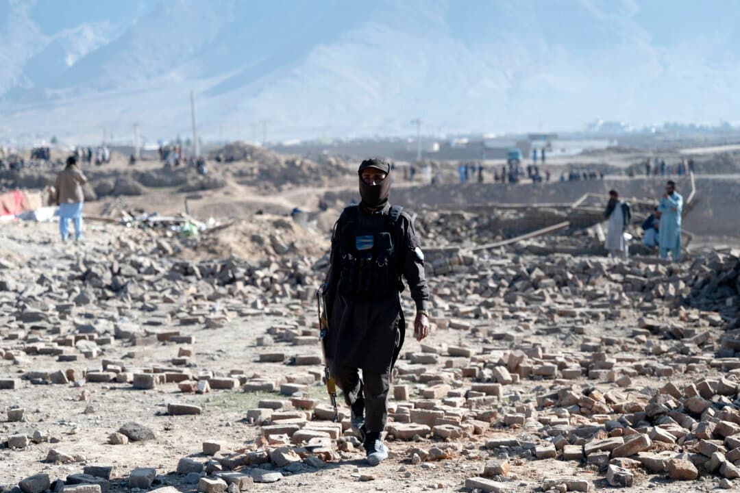 A member of the Taliban security personnel walks past rubble at the site of an overnight Pakistan airstrike, at a residential area in Pol-e-Charkhi on the outskirts of Kabul, Afghanistan, on March 13, 2026. Afghan authorities said that Pakistan had carried out new strikes on Kabul and border provinces, killing four people in the capital. (Wakil Kohsar/AFP via Getty Images)