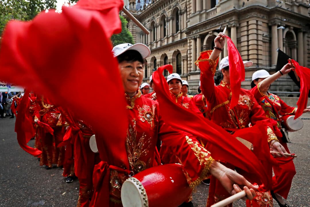 Asian Women at Work Inc. (AWatW) lead fellow activists through the central business district during the Sydney International Women's Day rally in Sydney, Australia, on March 13, 2026. International Women's Day is celebrated around the world on March 8 and is the focal point for the women's rights movement. (Lisa Maree Williams/Getty Images)