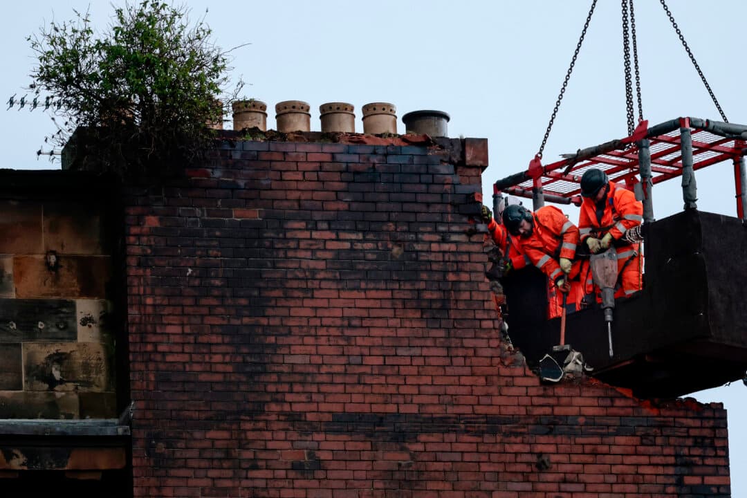 Demolition work begins on the fire-damaged building at Central Station in Glasgow, Scotland, on March 13, 2026. A major fire and explosion in buildings on Union Street on Sunday kept Glasgow's main station closed, with major disruptions to travel. (Jeff J Mitchel/Getty Images)
