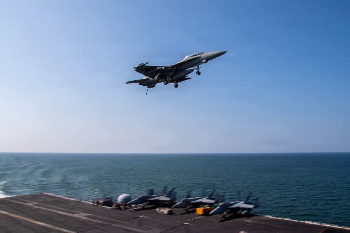 An F/A-18F Super Hornet, attached to Strike Fighter Squadron (VFA) 41, flies over the flight deck of Nimitz-class aircraft carrier USS Abraham Lincoln (CVN 72) in support of Operation Epic Fury on March 6, 2026. (U.S. Navy via Getty Images)