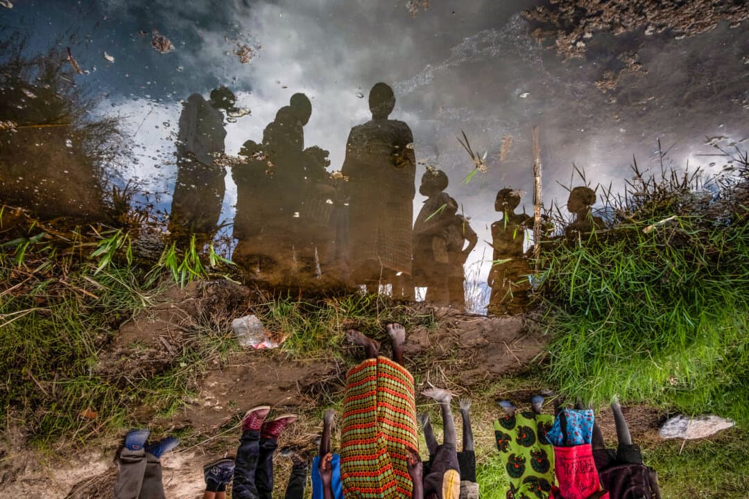 Villagers look upon a contaminated water source in southern Malawi on July 16, 2018. With 75 percent of the nation living on a daily income of less than $3 per day, Dahlin not only sees his wells as a way to keep people alive, but also a way to create opportunities for a population that is often skipped over on world maps. (John Fredricks/The Epoch Times)