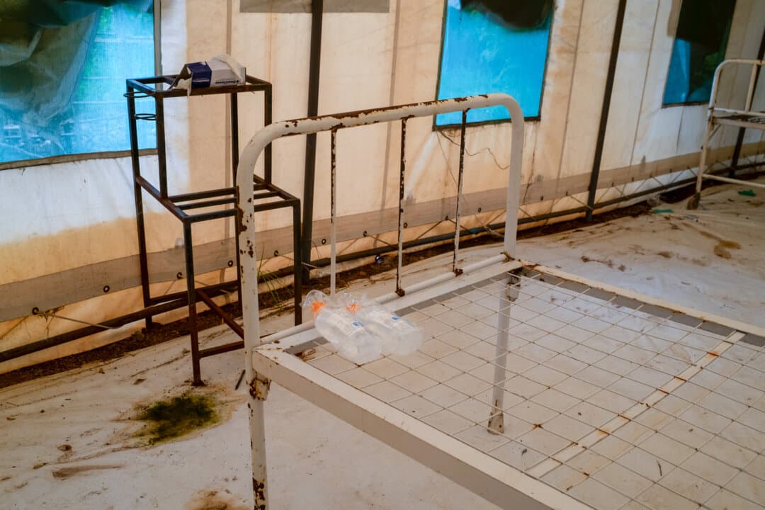 (Left–Right) A Cholera isolation area awaits patients outside of Monkey Bay, Malawi, on Feb. 18, 2026. Highly contagious, the disease requires isolation of the affected to prevent spreading, along with hydration treatments for recovery. (John Fredricks/The Epoch Times)