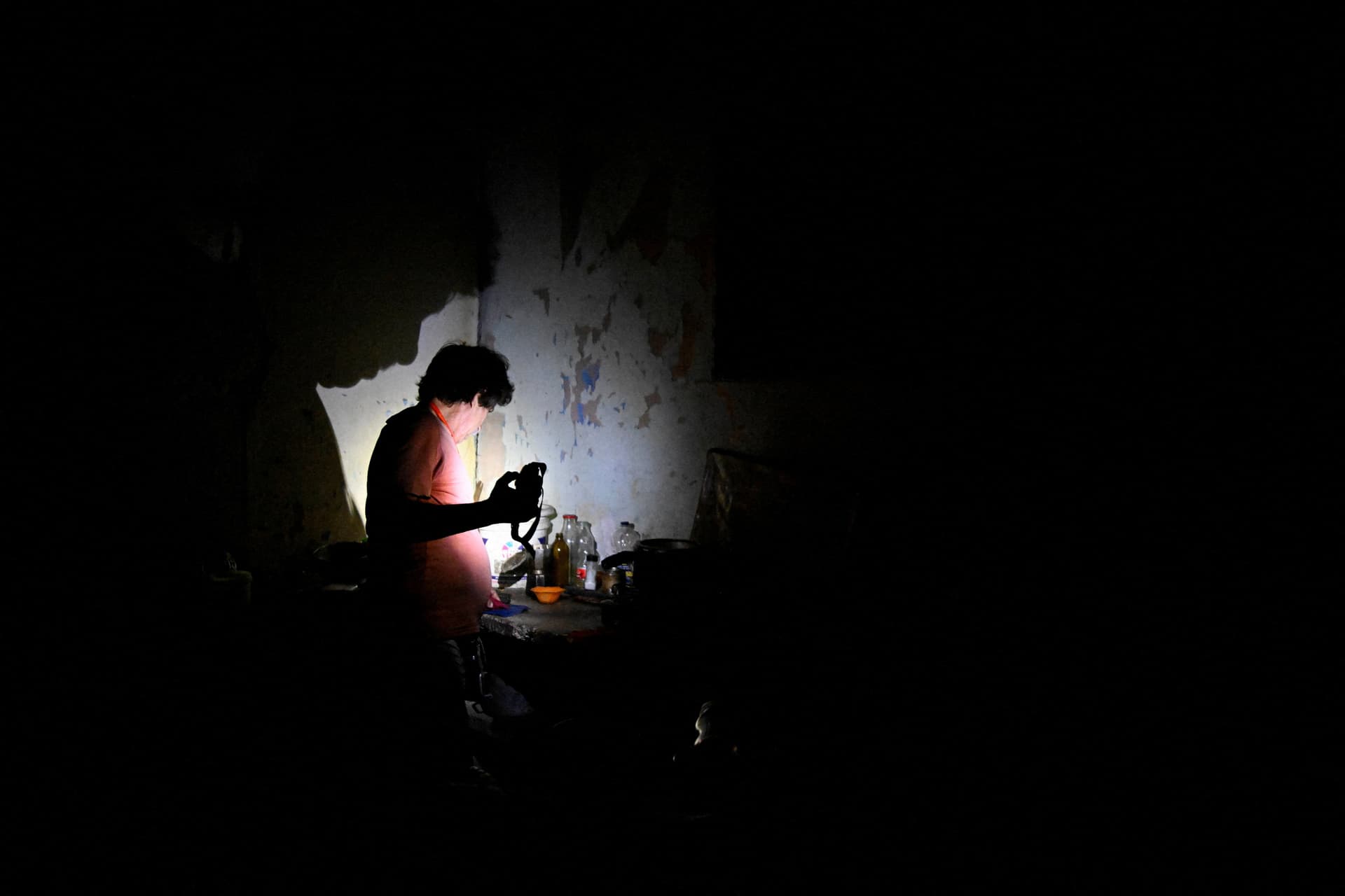 A man uses a flashlight during a blackout as Cuba's national electric grid collapsed, according to the country's grid operator, leaving about 10 million people without power amid a U.S.-imposed oil blockade, in Havana. (Norlys Perez/Reuters)