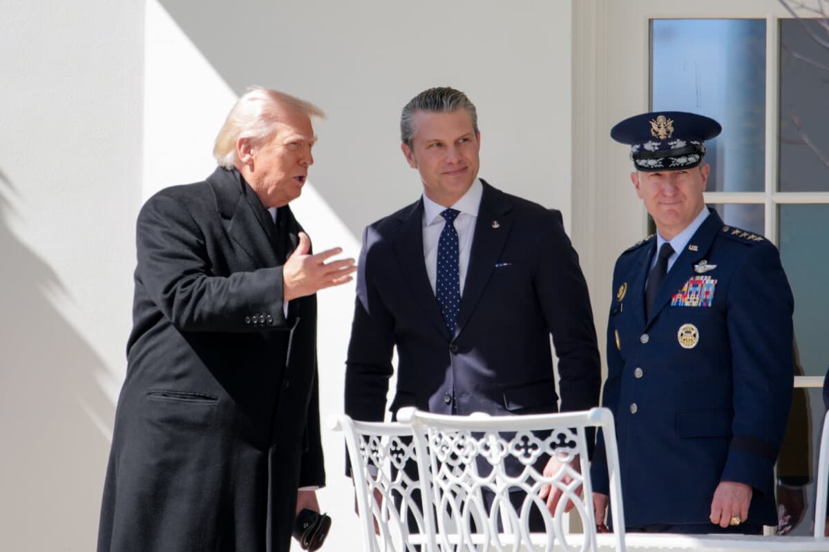 U.S. President Donald Trump, accompanied by U.S. Secretary of War Pete Hegseth and Chairman of the Joint Chiefs of Staff General Dan Caine, at the White House in Washington on March 18, 2026. (Andrew Harnik/Getty Images)