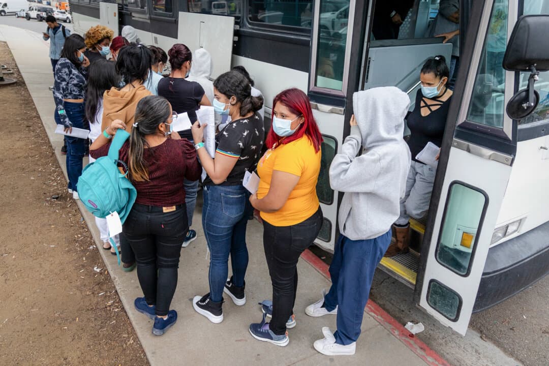 Buses drop off large groups of illegal immigrants in San Ysidro, Calif., on Feb. 29, 2024. (John Fredricks/The Epoch Times)