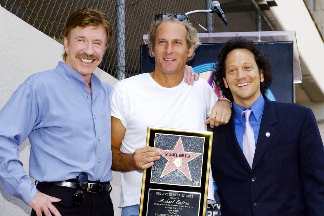 Singer-songwriter Michael Bolton (C) poses with actors Chuck Norris (L) and Rob Schneider at a ceremony honoring Bolton with a star on the Hollywood Walk of Fame in the Hollywood neighborhood of Los Angeles on Aug. 27, 2002. (Vince Bucci/Getty Images)