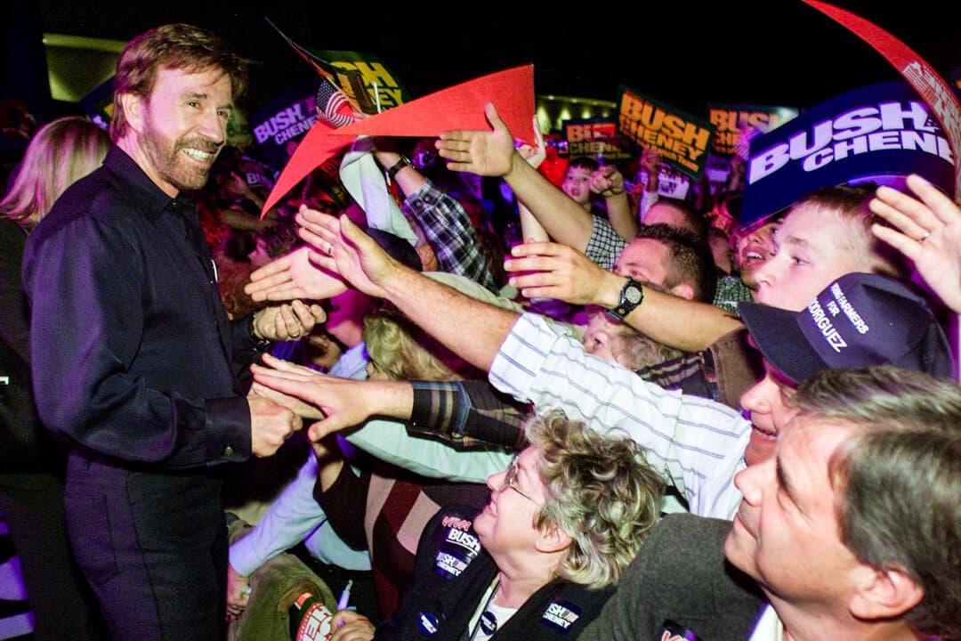 Actor Chuck Norris works the crowd to campaign for Republican Presidential candidate Texas Gov. George W. Bush during a rally of approximately 7,000 people inside the City of Fresno Convention Center in Fresno, Calif., on Oct. 30, 2000. (Paul J. Richards/AFP via Getty Images)