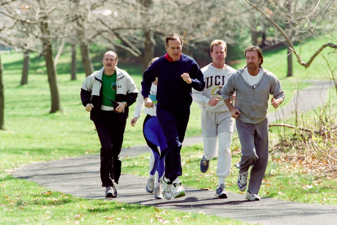 President George Bush (3rd R) jogs on March 21, 1990, with actor Chuck Norris (R) and his son Michael Norris (2nd R) at the U.S. Naval Observatory in Washington. (Luke Frazza/AFP via Getty Images)