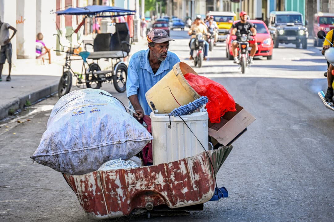 (Top Left) A man rummages through a dumpster in Havana on July 15, 2025. (Top Right) Homeless people sitting and lying on a street in Havana on July 21, 2025. (Bottom Left) A man begs for food on a street in Havana on July 21, 2025. (Bottom Right) A man carries collected garbage on a street in Havana on July 21, 2025. Poverty levels have increased sharply as the Caribbean country reckons with its worst economic crisis in three decades, marked by shortages of food, medicine, and fuel, as well as daily power blackouts. (Adalberto Roque/AFP via Getty Images, Yamil Lage/AFP via Getty Images)
