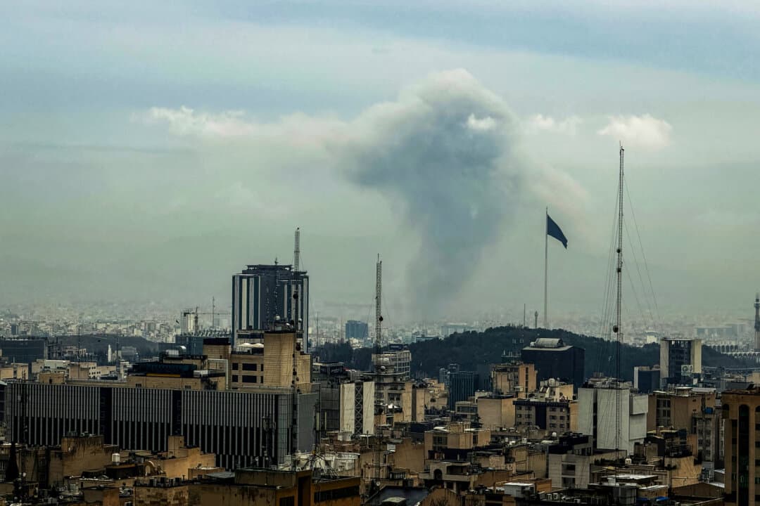 A plume of smoke rises from the site of a strike in Tehran, Iran, on March 16 (L) and March 17 (R), 2026. (Atta Kenare / AFP via Getty Images)