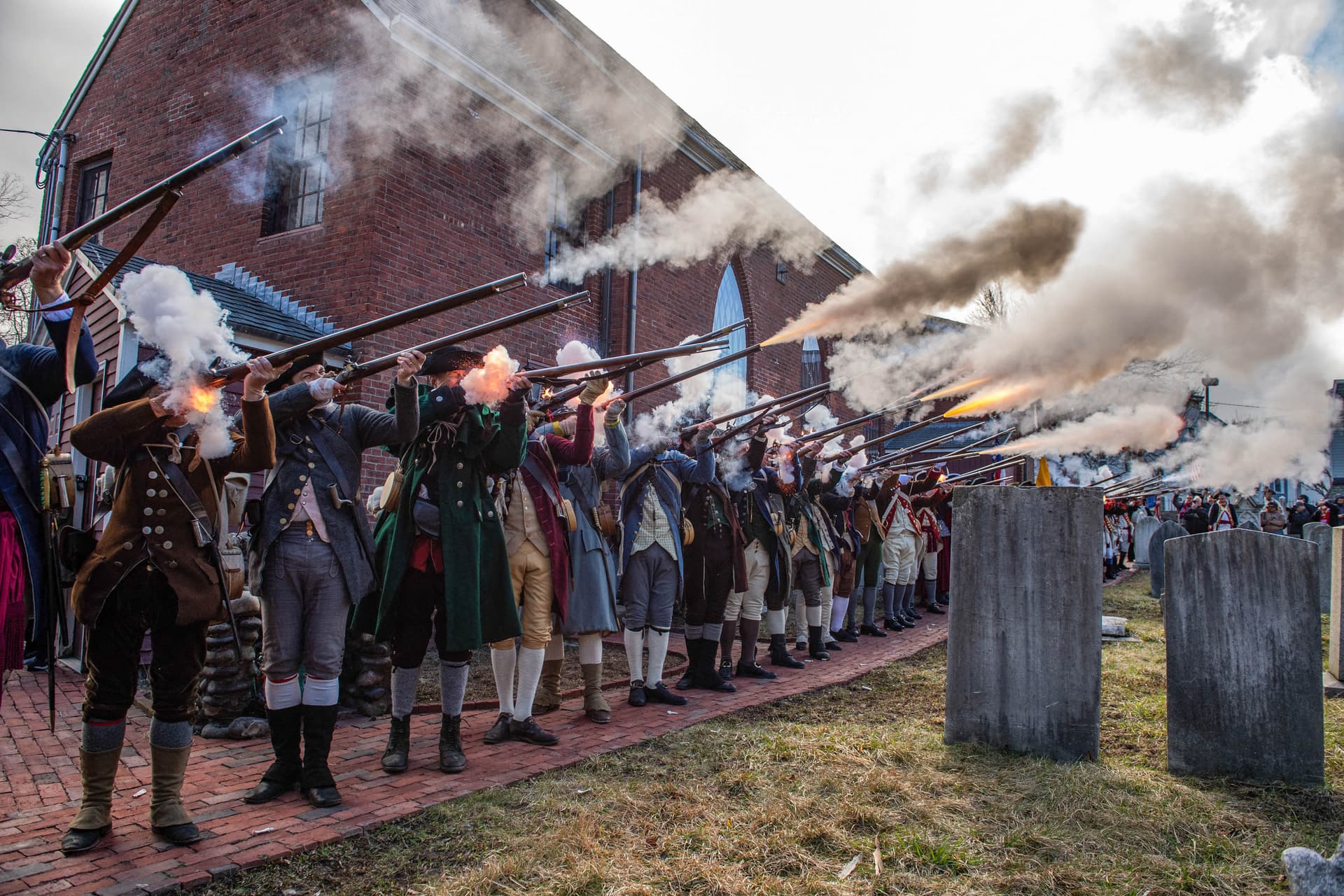 Revolutionary War reenactors fire off volleys at Saint Augustine's Chapel at the start of the Evacuation Day exercises in Boston, Mass., on March 17, 2026. March 17 marks the 250th anniversary of British forces evacuating Boston after the siege of Boston in 1776, during the early part of the American Revolutionary War. (Joseph Prezioso / AFP via Getty Images)