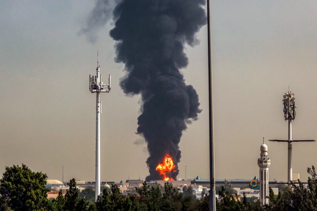 A smoke plume rises from a fire near Dubai International Airport in Dubai, United Arab Emirates, on March 16, 2026. Flights gradually resumed after a March 1 Iranian drone attack that was part of a broader wave of strikes targeting U.S. assets across the Gulf. (AFP via Getty Images)
