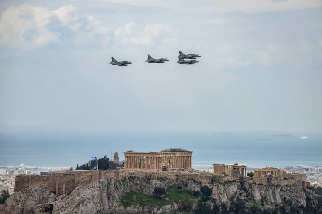 Hellenic Air Force fighter aircraft Dassault Mirage 2000 fly over the ancient temple of Parthenon atop the Acropolis hill during a military parade marking Greece's Independence Day in Athens on March 25, 2026. (Aris Messinis/AFP via Getty Images)