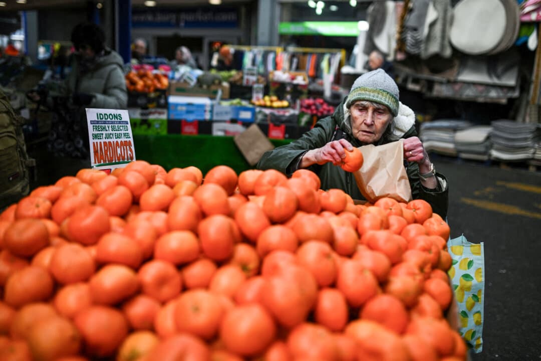 A shopper looks at fruit for sale at Bury Market in Bury, Greater Manchester, Britain, on March 25, 2026. Britain's annual inflation rate was unchanged at 3 percent in February, official data showed on March 25, ahead of an expected jump as the Middle East war has sent oil prices surging. (Oli Scarff/AFP via Getty Images)