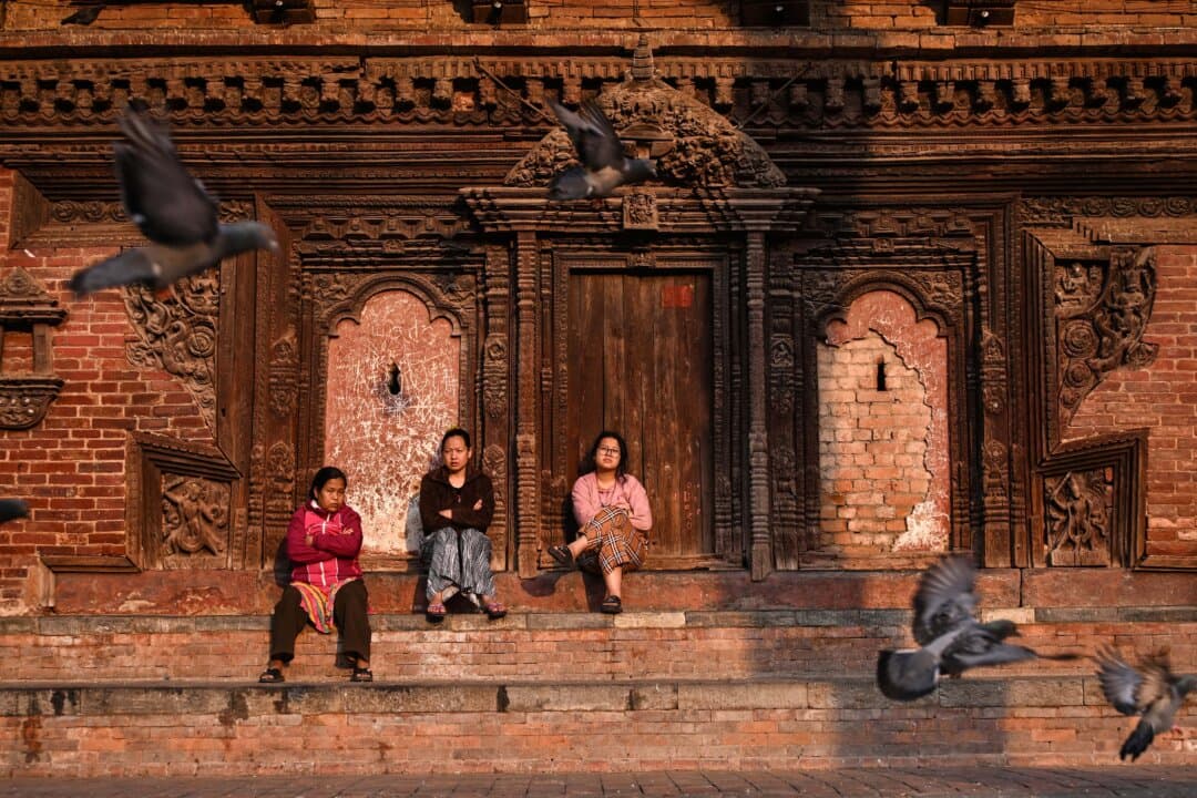 Women sit at Durbar Square in Kathmandu, Nepal, on March 25, 2026. (Prakash Mathema/AFP via Getty Images)