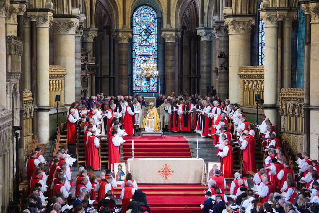 The Most Rev. Albert Chama, the primate of the Province of Central Africa, leads a prayer for the Archbishop of Canterbury Dame Sarah Mullally, seated in the Chair of St. Augustine during her Enthronement Ceremony at Canterbury Cathedral in Canterbury, UK, on March 25, 2026. Mullally, who worked as a nurse before being ordained, is the first woman to be appointed leader of the Church of England. (Gareth Fuller/WPA Pool/Getty Images)
