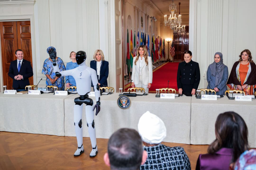 A humanoid robot greets guests as First Lady Melania Trump hosts the Fostering the Future Together Global Coalition Summit in the East Room of the White House on March 25, 2026. Melania Trump held a roundtable at the White House on the second day of the inaugural summit to promote access to education and technology for children worldwide. (Heather Diehl/Getty Images)