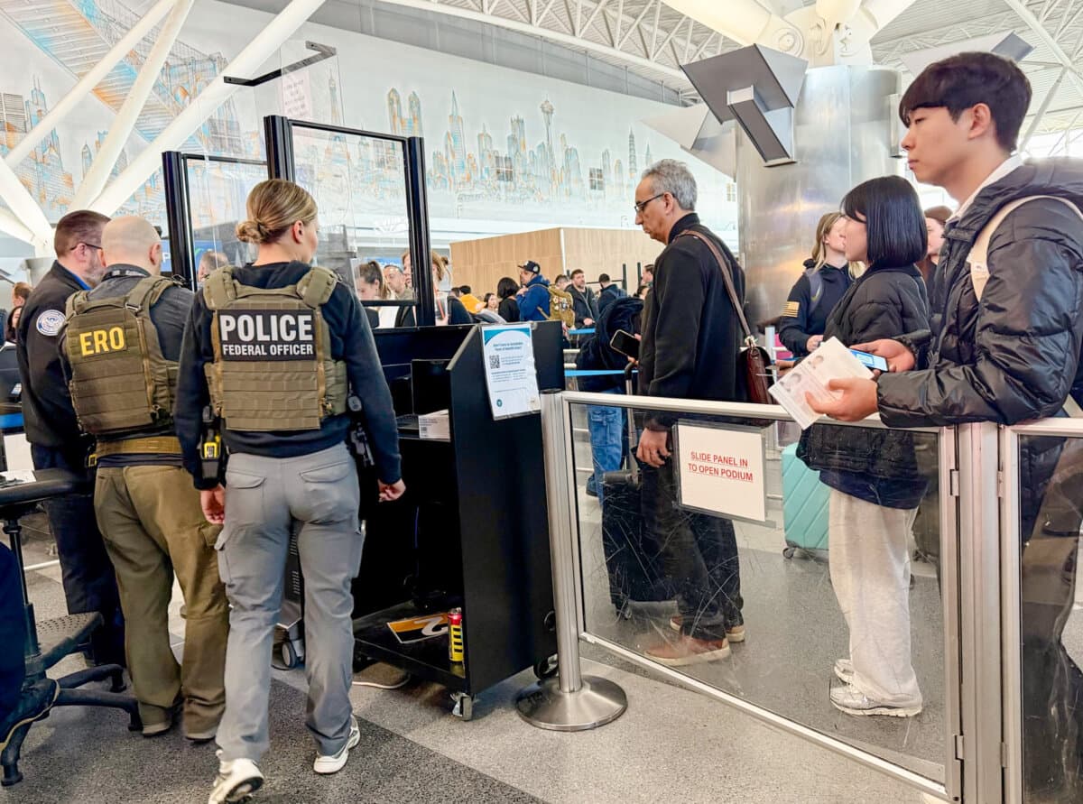 ICE agents assist TSA officers at John F. Kennedy Airport on March 26, 2026. (This image has been digitally altered to conceal personal identification.) (The Epoch Times)