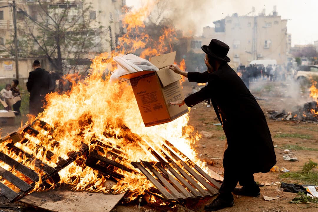 An ultra-Orthodox Jewish man burns leavened bread and items in final preparation for the Passover holiday in Netanya, Israel, on April 1, 2026. (Amir Levy/Getty Images)