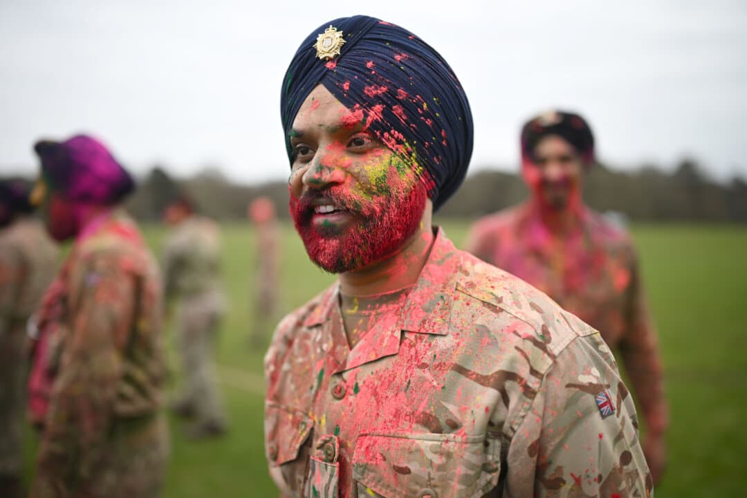 Sikh soldiers are covered with colored powder paints during the culmination of the ceremony to mark Holi Mohalla during the Sikh Military Festival of Holla Mohalla at Royal Military Academy Sandhurst in Camberley, England, on April 1, 2026. (Leon Neal/Getty Images)