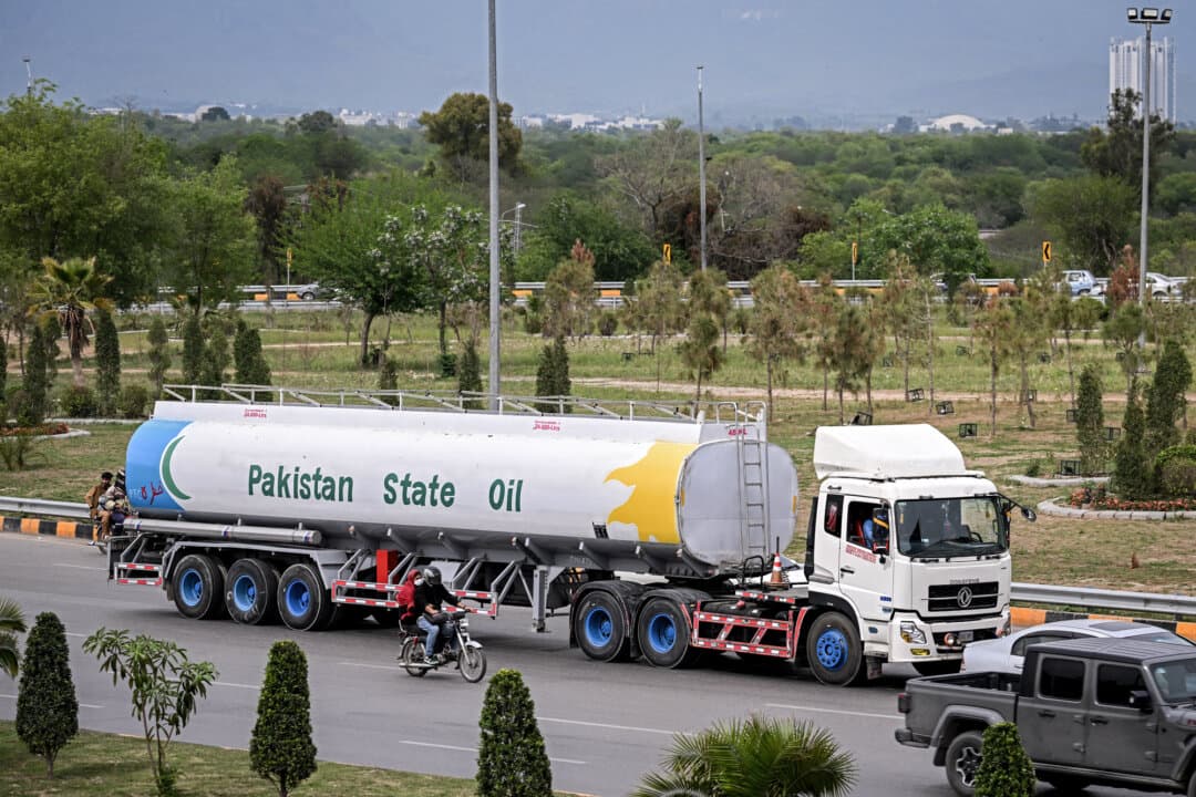 Commuters ride past an oil tanker along a street in Islamabad on March 28, 2026. Brent crude, the global oil benchmark, has risen to more than $100 per barrel, while gasoline prices have climbed to more than $4 per gallon. (Farooq Naeem/AFP via Getty Images)
