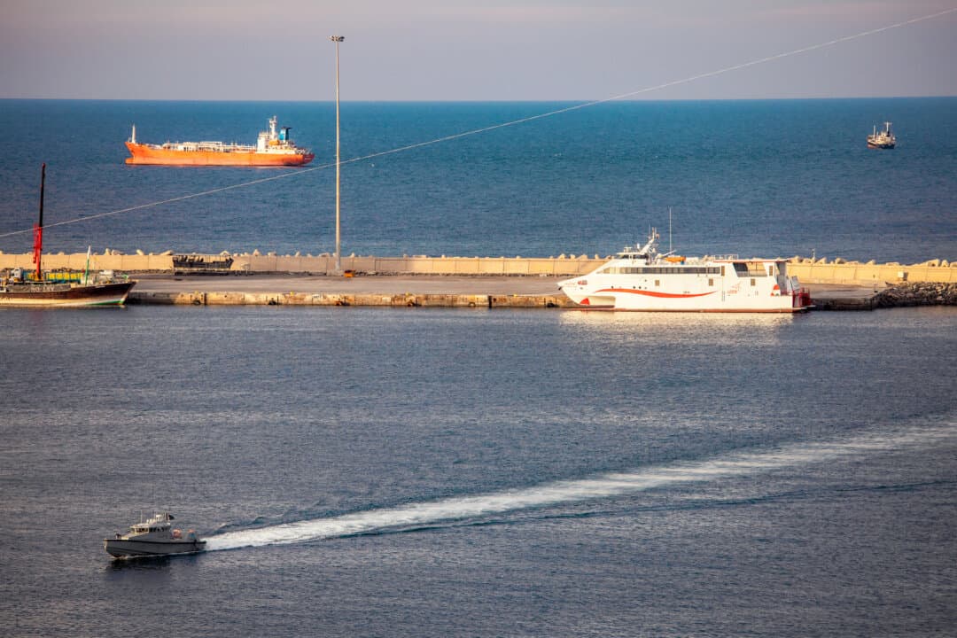 A police speedboat patrols the port as oil tankers and high-speed craft sit anchored near the Strait of Hormuz in Muscat, Oman, on March 30, 2026. Iran’s attacks on commercial vessels have disrupted traffic along the vital waterway, which previously carried about 25 percent of the world’s seaborne oil trade, according to the International Energy Agency. (Elke Scholiers/Getty Images)