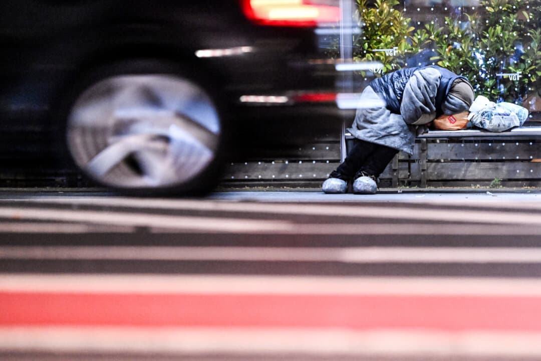 A homeless person sleeps at a bus stop in the city of Frankfurt am Main, Germany, early on April 2, 2026. (Kirill Kudryavtsev/AFP via Getty Images)