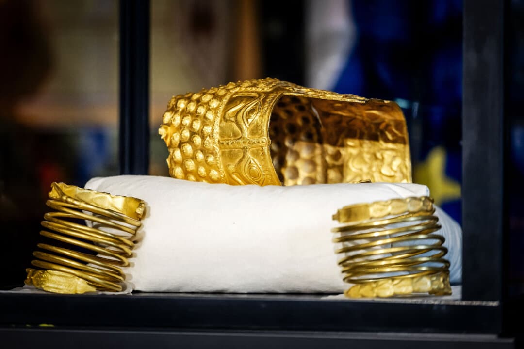 The recovered golden helmet of Cotofenesti and two gold bracelets that were stolen from the Drents Museum are displayed in a glass box in Assen in the Netherlands on April 2, 2026. A priceless gold 2,500-year-old helmet from Romania that was stolen last year in the Netherlands has been recovered, Dutch art detective Arthur Brand told AFP on April 2, 2026. (Sem van der Wal/ANP/AFP via Getty Images)