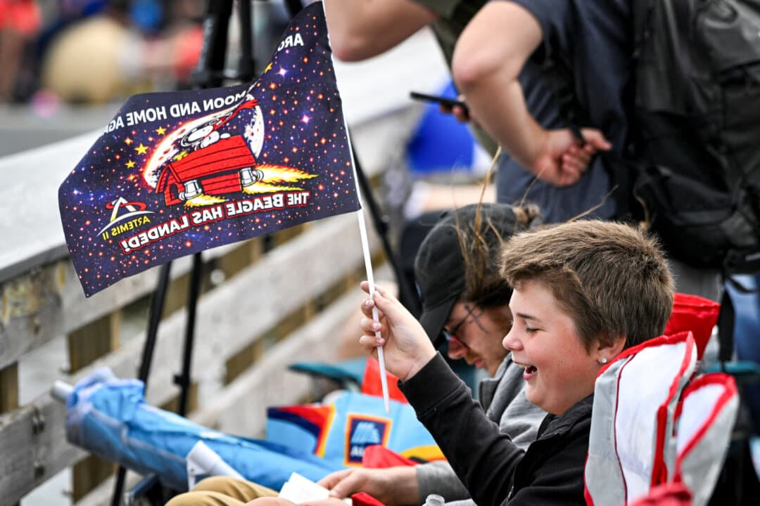 Space enthusiasts gather at a park in Titusville, Fla., several hours before NASA's Artemis II Space Launch System rocket is scheduled to launch from Kennedy Space Center on Cape Canaveral on April 1, 2026. (Miguel J Rodriguez Carrillo/AFP via Getty Images)