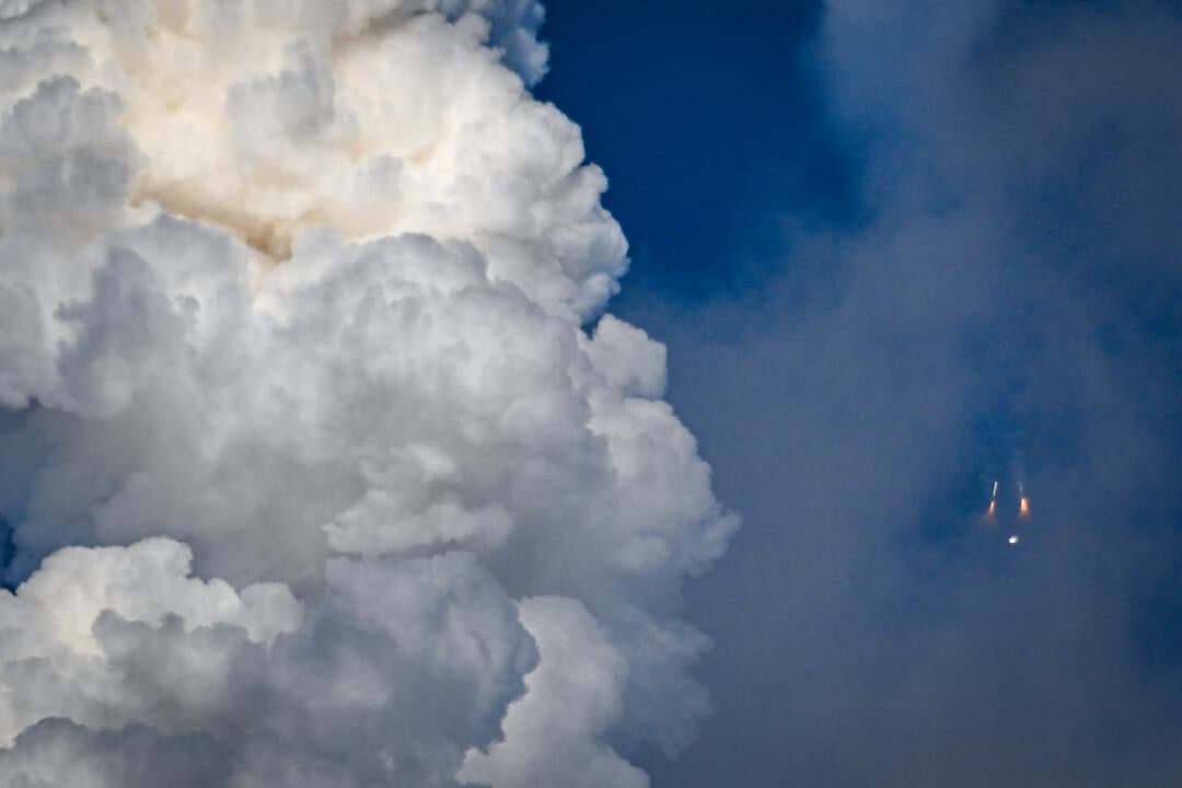 The solid rocket boosters are seen as they fall away after separating from NASA's Space Launch System rocket shortly after the Artemis II crewed lunar mission lift off from Pad 39B at Kennedy Space Center in Cape Canaveral, Fla., on April 1, 2026. (Miguel J Rodriguez Carrillo/AFP via Getty Images)