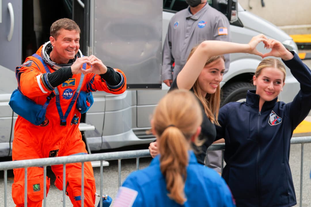 Commander Reid Wiseman (L) takes a photo with his family as he walks out of the Neil A. Armstrong Operations and Checkout Building ahead of the launch of the Artemis II at NASA’s Kennedy Space Center in Cape Canaveral, Fla., on April 1, 2026. (Chip Somodevilla/Getty Images)
