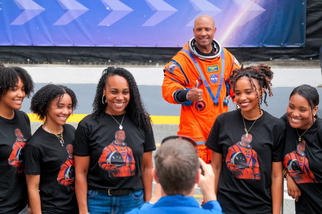 Pilot Victor Glover poses for a photo with his family as he walks out of the Neil A. Armstrong Operations and Checkout Building ahead of the launch of the Artemis II at NASA’s Kennedy Space Center in Cape Canaveral, Fla., on April 1, 2026. (Chip Somodevilla/Getty Images)